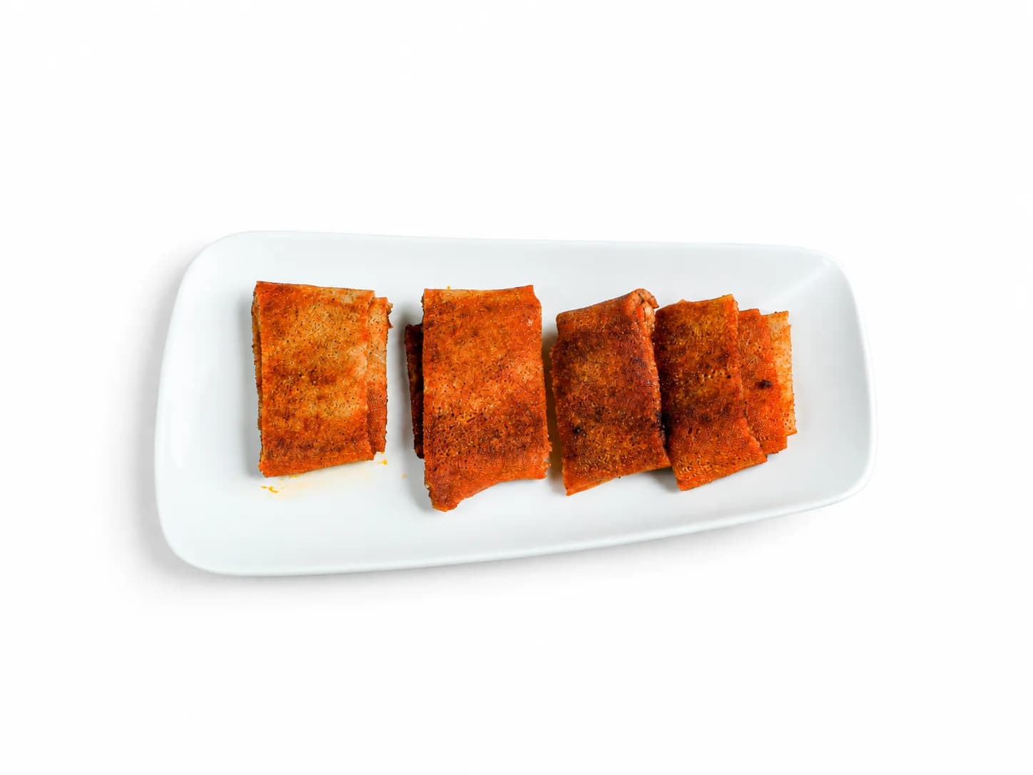 Toasted Kategna pieces with berbere on a white plate