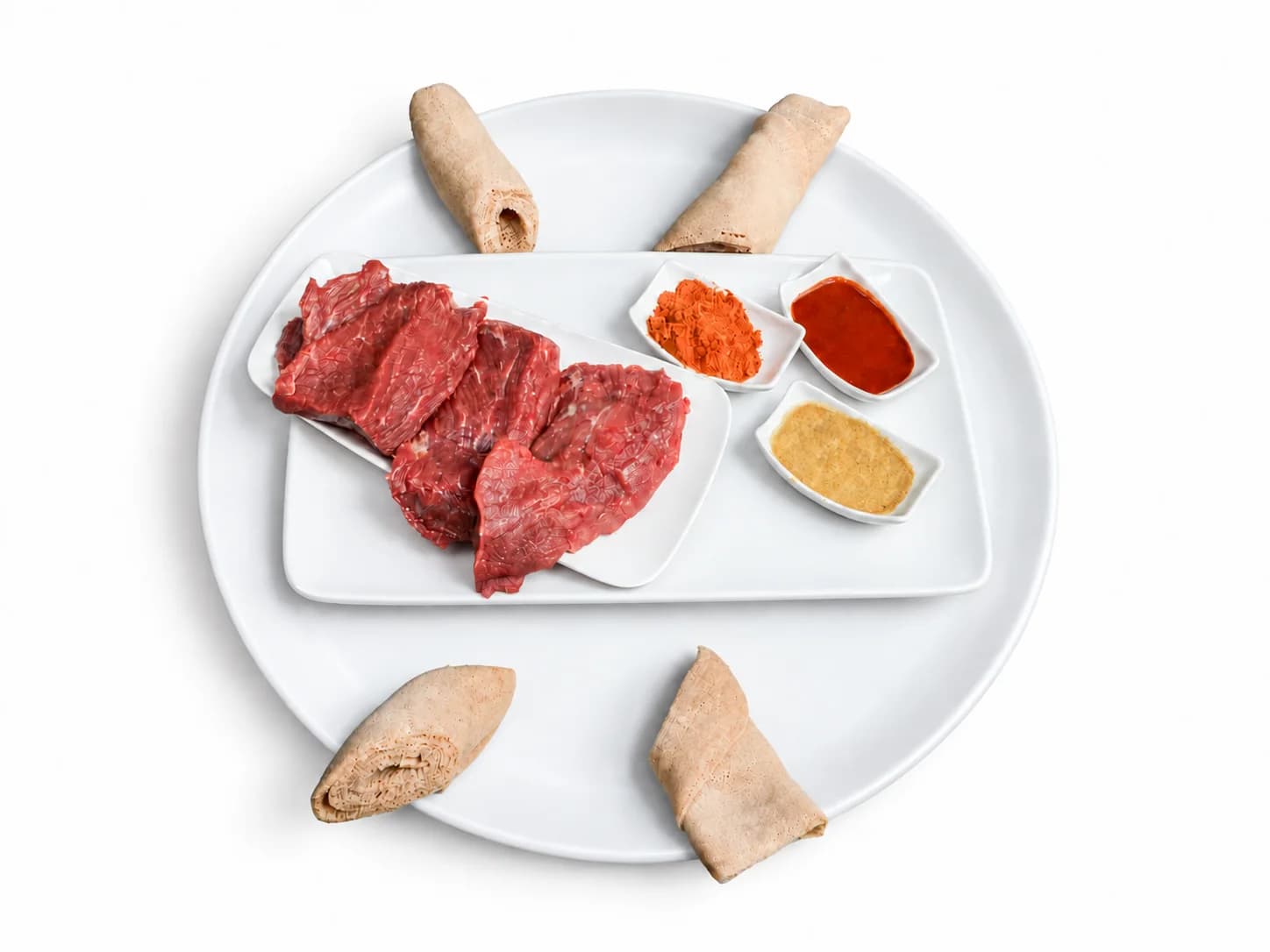 Kurt with raw beef, spices and rolled injera