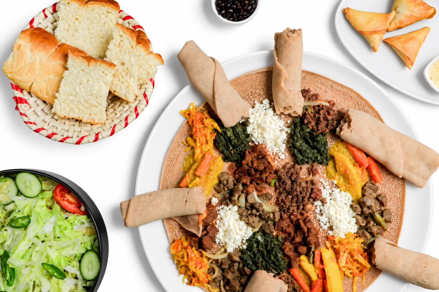 Große Injera-Platte mit Fleischgerichten, Gemüse, Ayib und Beilagen